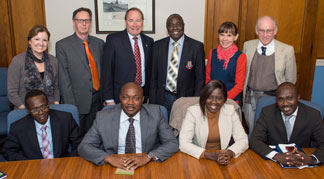 Ghana scholars and URI faculty and staff meet in President David M. Dooley’s office, from left to right in back, Nancy Stricklin, assistant to the provost for Global Strategies and Academic Partnerships; Anton Post, director of the Coastal Resources Center; President Dooley; Domwini Dabire Kuupole; Elin Torell, international program director for the Coastal Resources Center; and Don Robadue, project manager at the Coastal Resources Center. Seated in front, left to right, Johnson Boampong; Ernest Okorley; and Rosemond Boohene; Denis Worlanyo Aheto.(credit: Nora Lewis, URI)