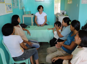 A rural health midwife explains family planning and the PHE link in  Ubay, Bohol, Philippines. (Credit: PFPI)